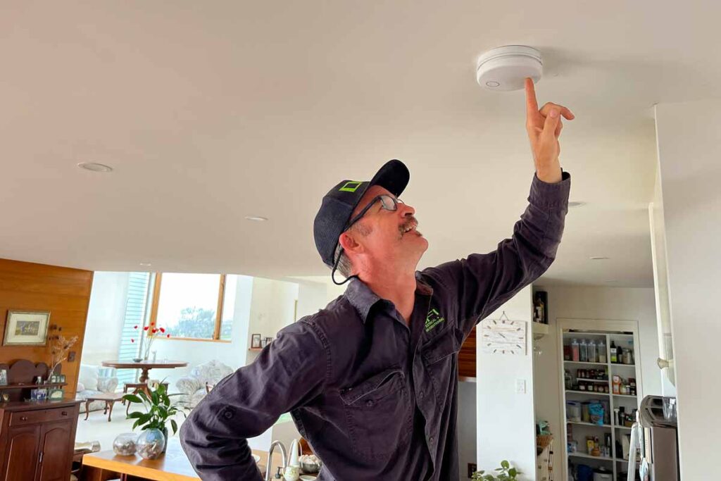 Glen from DFI checking a smoke alarms