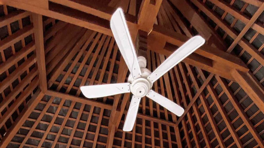 a ceiling fan in a wooden roof